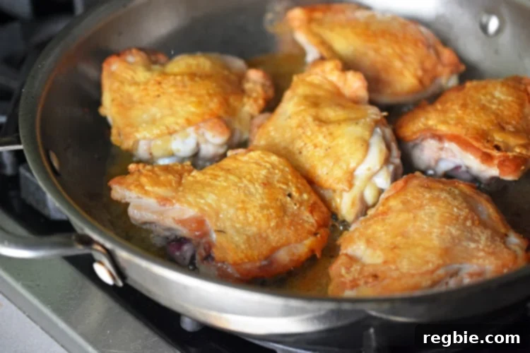 Golden-Crisp Cantonese Chicken Thighs 14 A closeup of a pan of Cantonese Crispy Chicken Thighs with crispy skin.