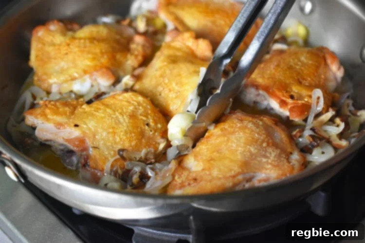 Golden-Crisp Cantonese Chicken Thighs 16 Adding the reserved vegetables back to the pan of Cantonese Crispy Chicken Thighs