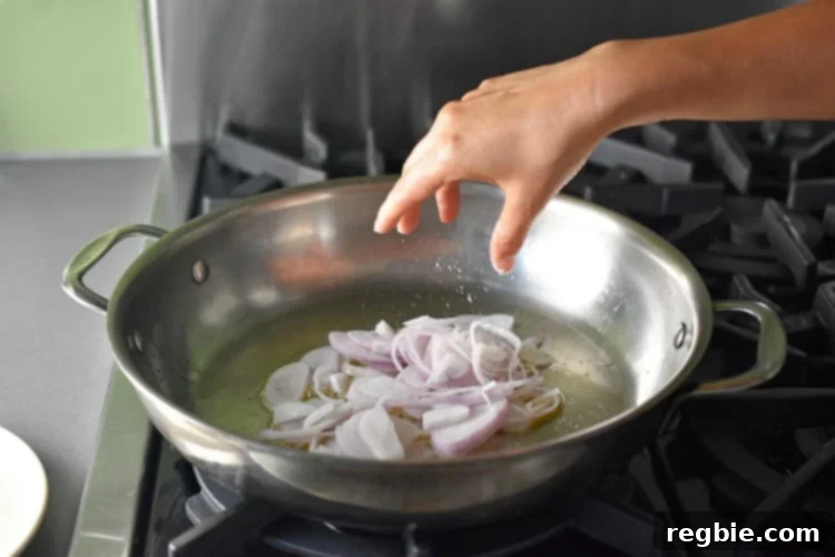 Golden-Crisp Cantonese Chicken Thighs 4 Sautéing some sliced shallots in a sauce pan