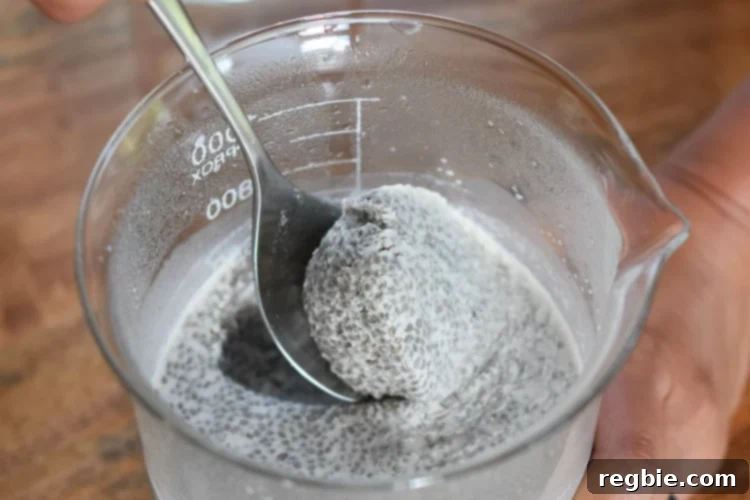 A spoon scooping out the cooled chia seed coconut milk mixture.