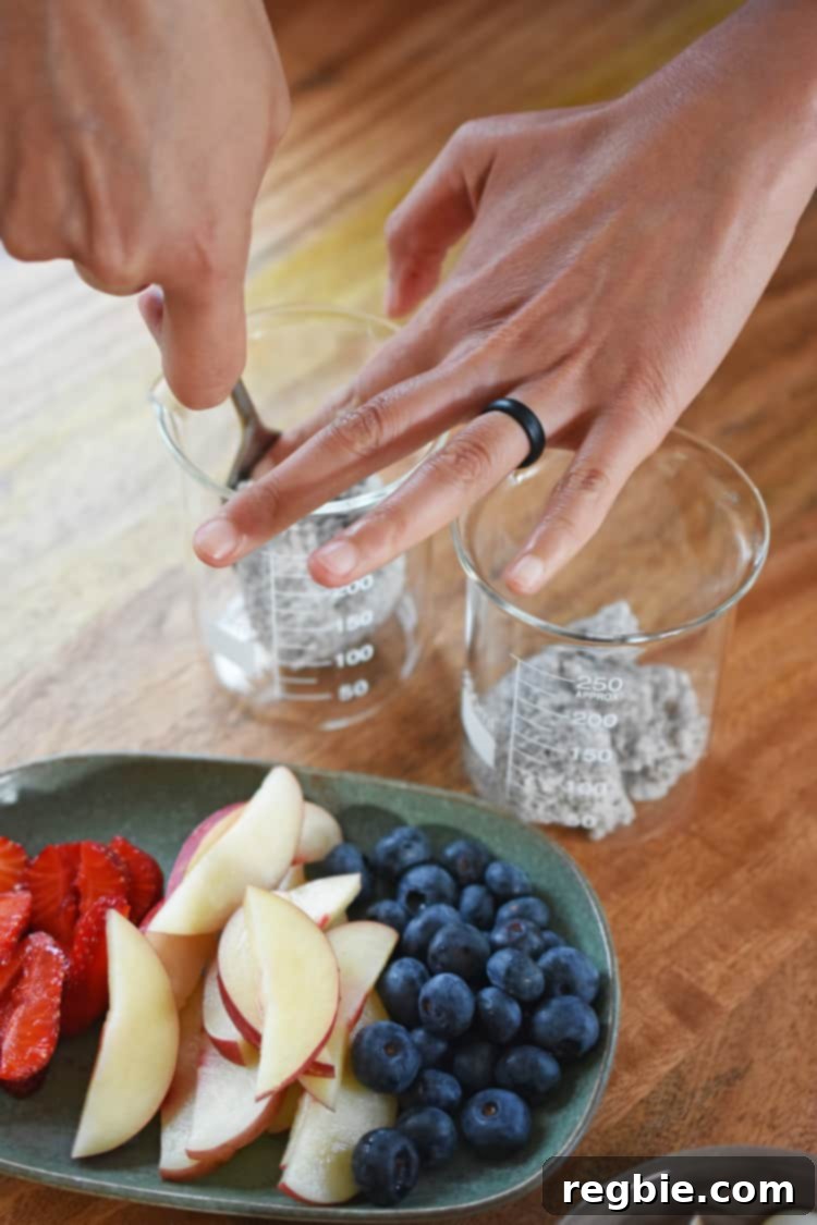 A plate of fruit is next to the containers of coconut chia pudding.