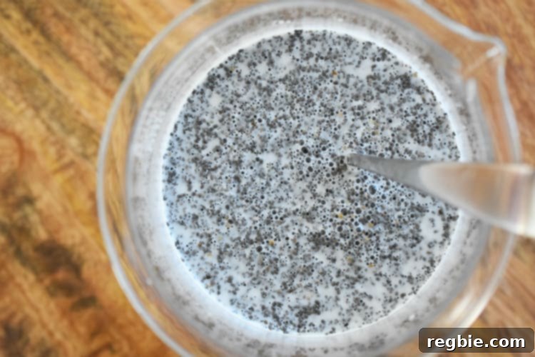 An overhead shot of the chia seeds mixed with the milk in a large measuring container.