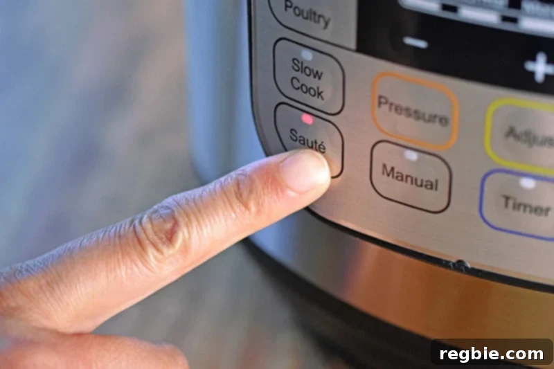 A finger is pressing the Sauté button on an Instant Pot to initiate cooking for Summer Italian Chicken stew.