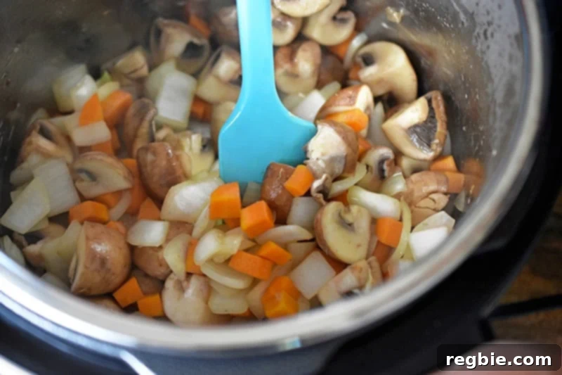 Sauteing the vegetables in an open Instant Pot to make Whole30 Summer Italian Chicken.