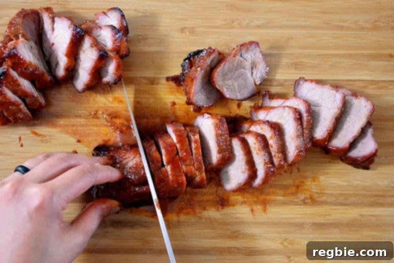 Paleo Char Siu (Chinese BBQ Pork) sliced into delicious 1/2-inch pieces on a wooden cutting board, ready to be served.