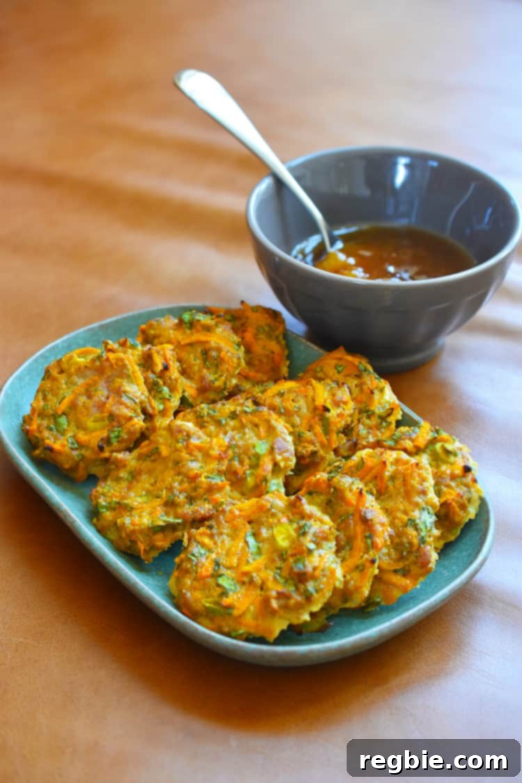 A shot of a platter of Whole30 Curry Turkey Bites next to a bowl of homemade Apricot-Ginger Sauce.