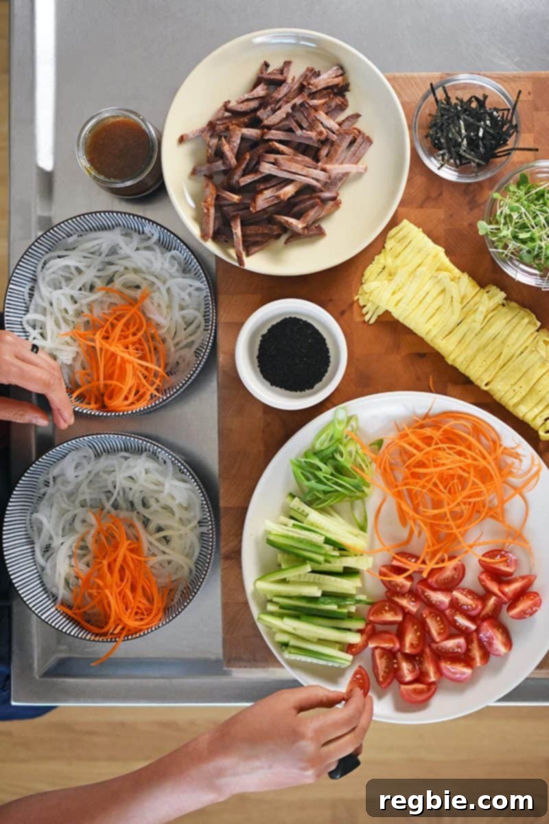 An overhead shot showcasing all the beautifully prepped ingredients for Paleo Hiyashi Chūka, ready for assembly.