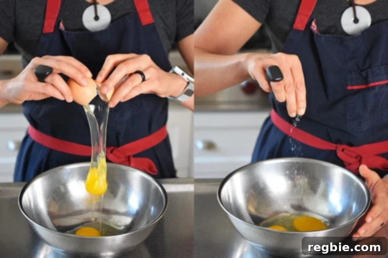 Cracking an egg into a metal bowl and sprinkling kosher salt, preparing for the omelet.