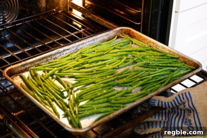 Crisp Lemon-Garlic Roasted Green Beans 7 Putting a rimmed baking sheet with green beans into an oven.