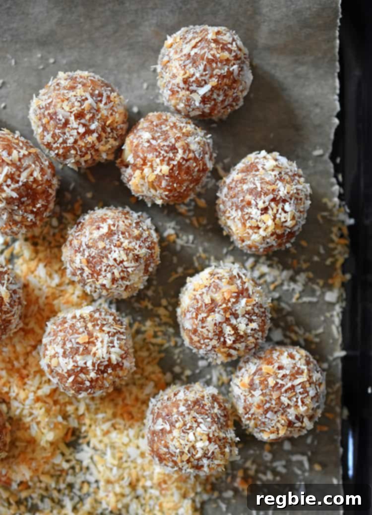 An inviting overhead photograph of perfectly formed, healthy, paleo, and no-cook energy balls (Liar Balls) thoughtfully arranged on a piece of parchment paper, presenting a tempting visual that beckons immediate enjoyment.