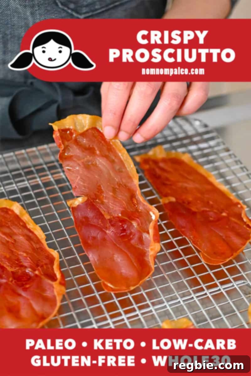 Golden Prosciutto Snaps 2 A hand is lifting a crispy prosciutto chip off of a wire cooling rack.