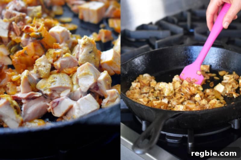 Cubed cooked chicken being stirred into the pan with the fragrant kimchi and onion mixture, warming through.