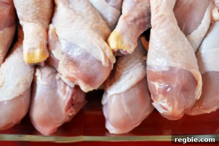 Wholesome Whole30 Cherry Chicken 7 Raw chicken drumsticks arranged neatly in a large bowl.