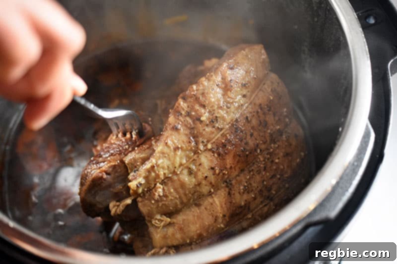 A fork is stabbed into the Pot Roast to check if it is tender