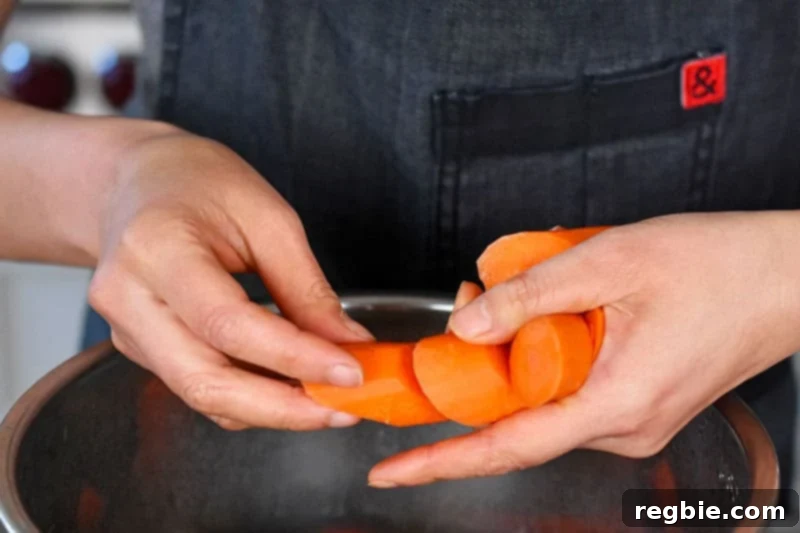 Sliced carrots are added to an Instant Pot.