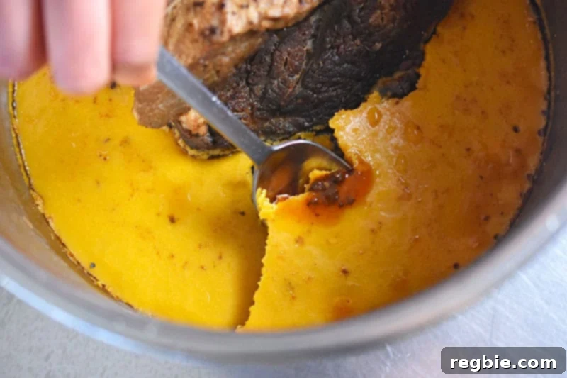 The hardened fat cap is removed from chilled Instant Pot Yankee Pot Roast 