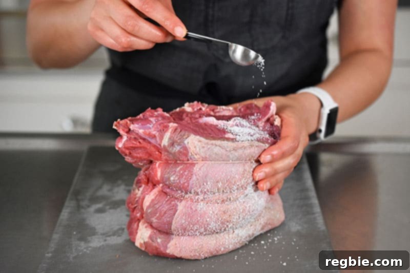 Seasoning a tied up chuck roast with salt