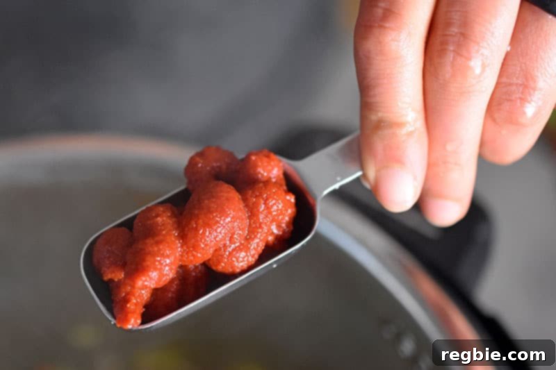 A tablespoon of tomato paste is added to the Instant Pot