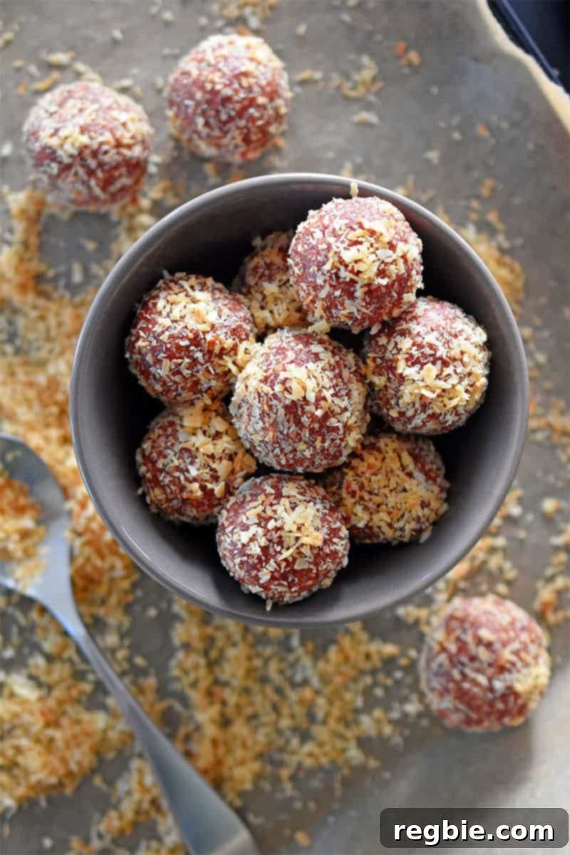 Peanut Butter Jelly Power Bites 2 An overhead shot of a bowl of vibrantly colored “PB&J” Energy Balls, showcasing these healthy, no-bake Paleo and vegan snacks.