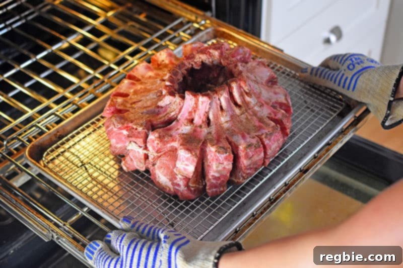 Putting the Magic Crown Roast of Pork into the oven to begin the slow roasting process.