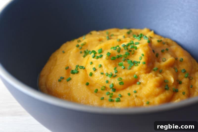 Instant Pot Wholesome Autumn Mash 3 A close-up of a rustic bowl filled with creamy, paleo and Whole30 Instant Pot Autumn Mash, garnished with fresh herbs, ready to serve.