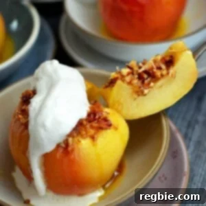 A perfectly baked apple, beautifully topped with whipped coconut cream, with a slice removed to reveal a rich, nutty filling inside.