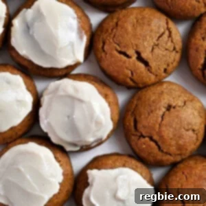 An overhead shot of a tempting plate brimming with paleo and gluten-free pumpkin cookies, some elegantly frosted and others showcasing their natural golden hue, inviting a delicious bite.
