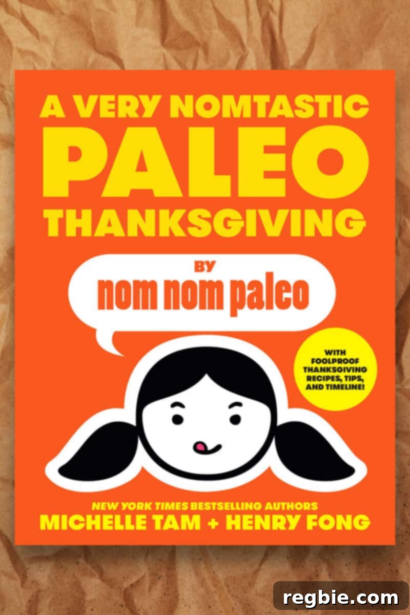 The vibrant cover of the 'A Very Nomtastic Paleo Thanksgiving' e-book, showcasing an enticing array of holiday dishes and promising a guide to a delicious, healthy celebration.