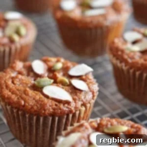 A delectable Paleo Pumpkin and Carrot Muffin, showcasing its tender crumb and inviting autumnal colors, promising a wholesome and tasty treat.