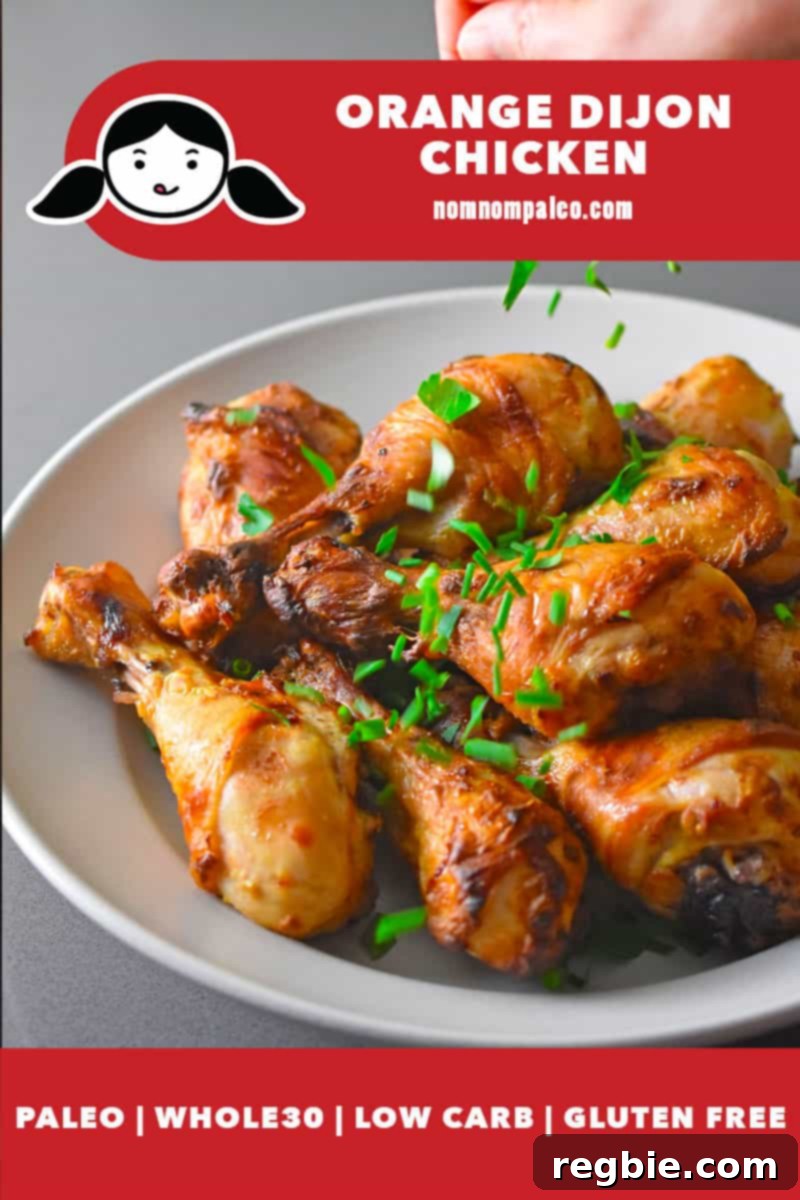 Someone sprinkling fresh herbs on a platter of paleo Orange Dijon Chicken. There is a red banner at the bottom that says paleo, Whole30, low-carb, and gluten-free