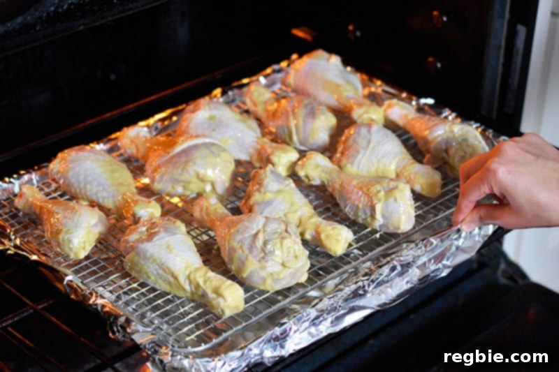 Someone putting the orange dijon chicken into the oven.
