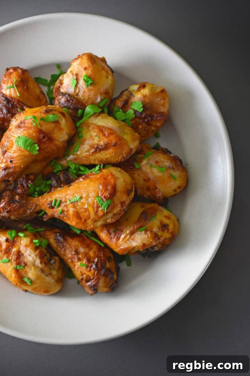 A plate of paleo orange dijon chicken with parsley.