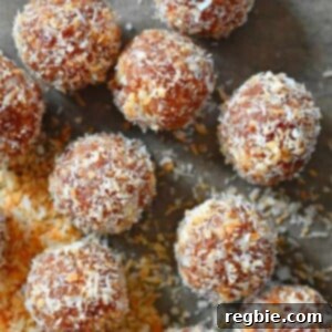 An overhead shot of healthy, paleo, no-cook energy balls resting on a piece of parchment paper, showcasing their inviting texture.