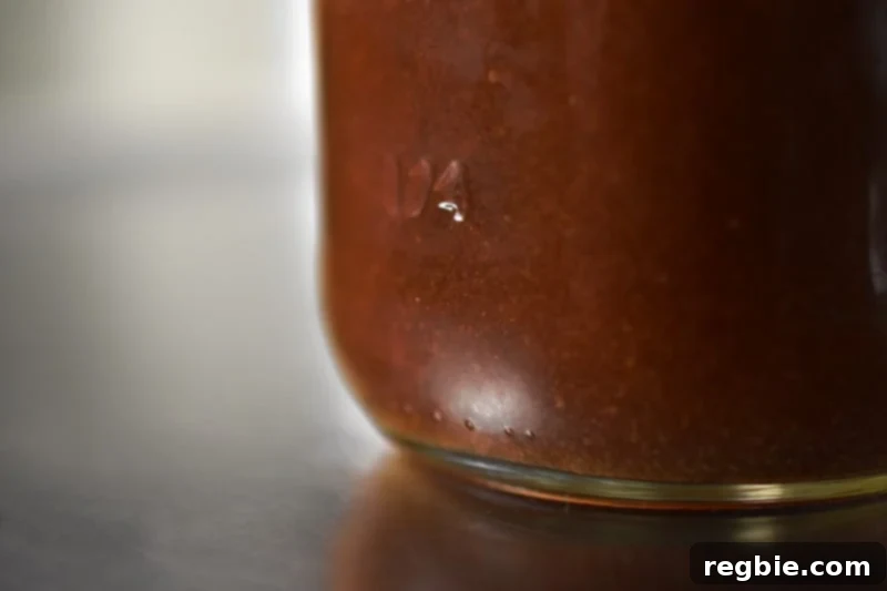 A close-up shot of a mason jar filled with the ready-to-use All-Purpose Stir-Fry Sauce, showcasing its rich texture and color.