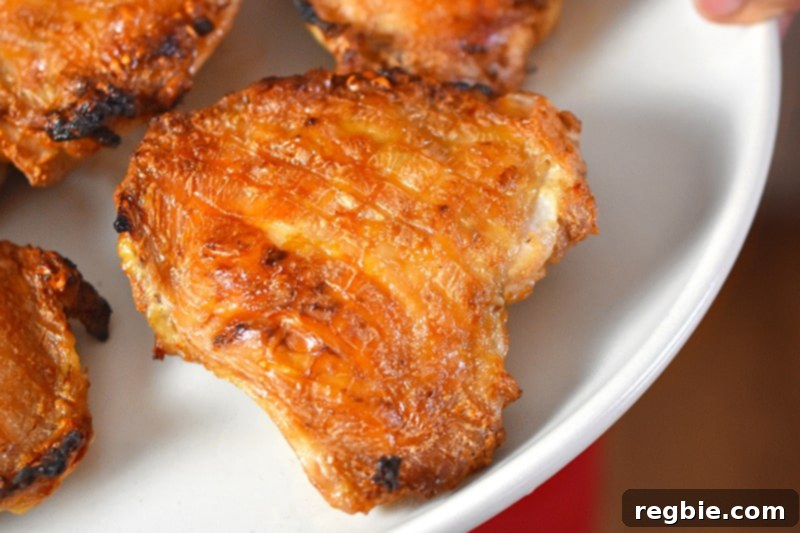 Umami-Rich Roasted Chicken Whole30 Keto 11 A close-up shot of several succulent Umami Roast Chicken thighs on a serving platter, highlighting their golden-brown, crispy skin and juicy appearance.
