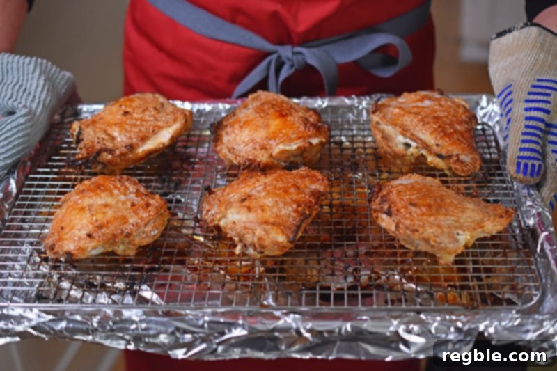 Umami-Rich Roasted Chicken Whole30 Keto 10 A finished tray of perfectly roasted Umami Roast Chicken thighs, fresh from the oven, with crispy, golden-brown skin.