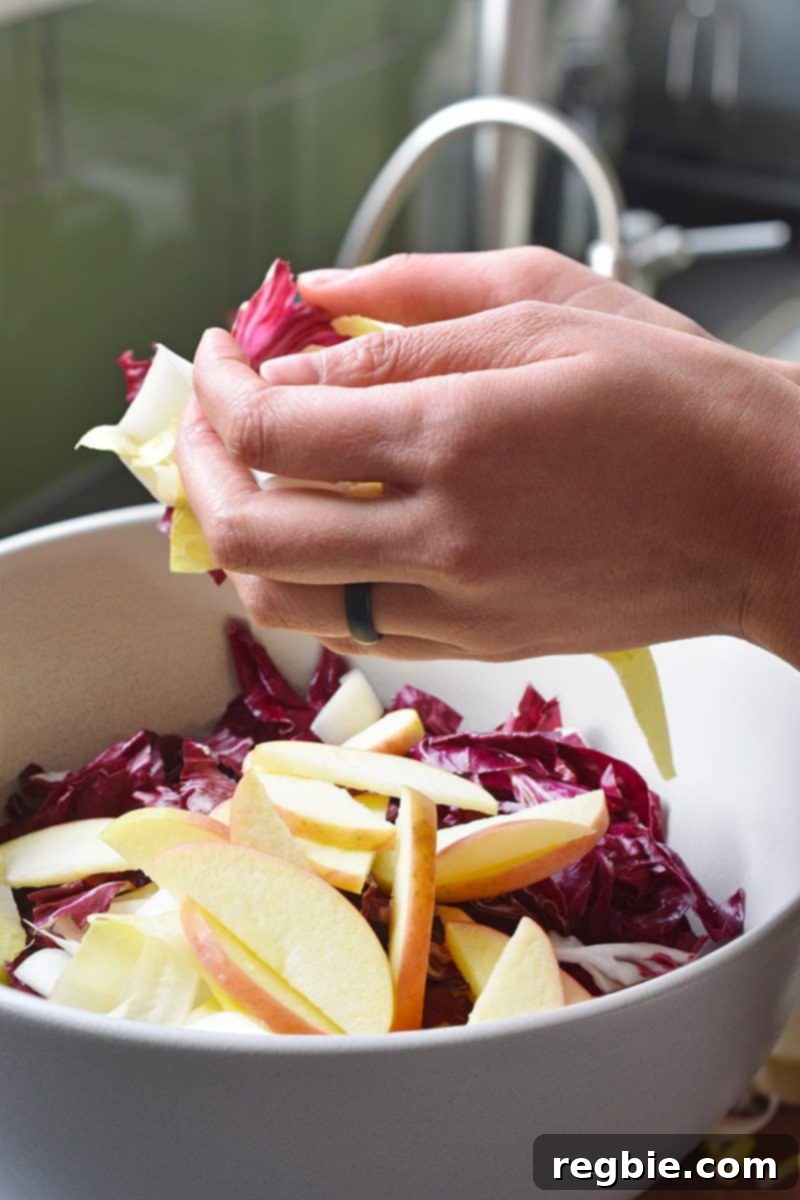 Golden Apple & Bitter Greens 10 Combining the endives and apples in a bowl.