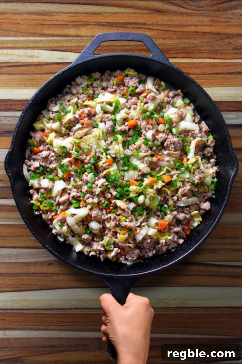 An inviting overhead shot of a frying pan brimming with Egg Roll in a Bowl, showcasing its vibrant colors and delicious texture, ready to be served.