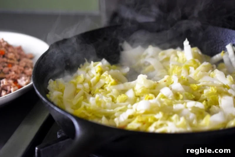Sautéing thinly sliced Napa cabbage in a cast iron skillet until wilted and tender, absorbing residual flavors.