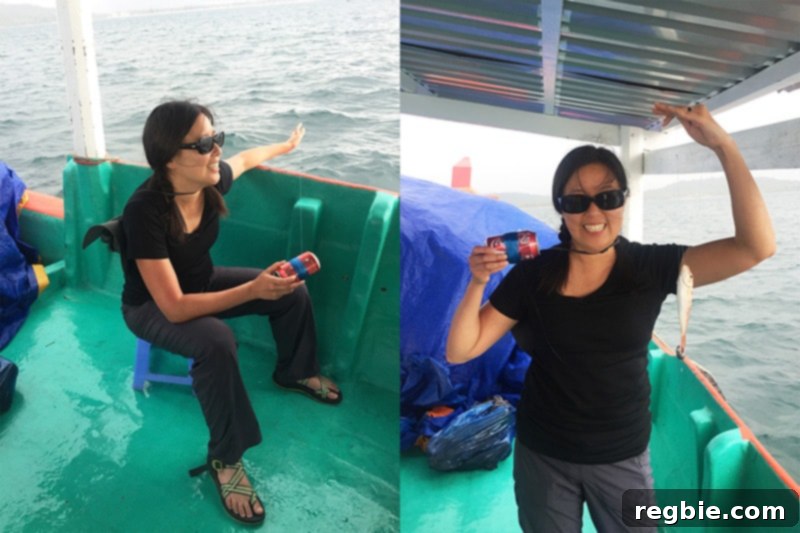 Michelle Tam proudly holding a fish caught with an empty soda can during her Vietnam trip.