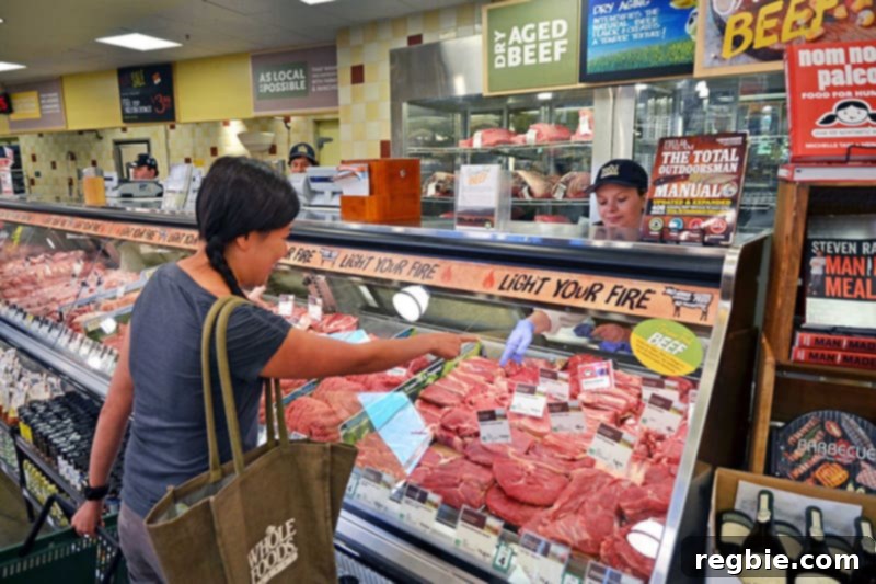 Mastering Your Paleo Pantry 4 An Asian woman shopping for high-quality meat at a butcher counter for her Paleo pantry.