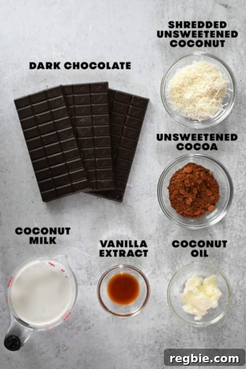 An overhead shot of the raw ingredients laid out to make paleo and vegan chocolate truffles, including chocolate bars, coconut oil, coconut milk, vanilla, and shredded coconut.