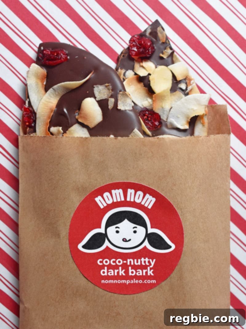 Paleo Coco-Nutty Dark Bark is perfect for DIY homemade edible holiday gifts because the recipe is drop-dead simple and infinitely customizable, showcasing rich dark chocolate with toasted coconut and nuts.
