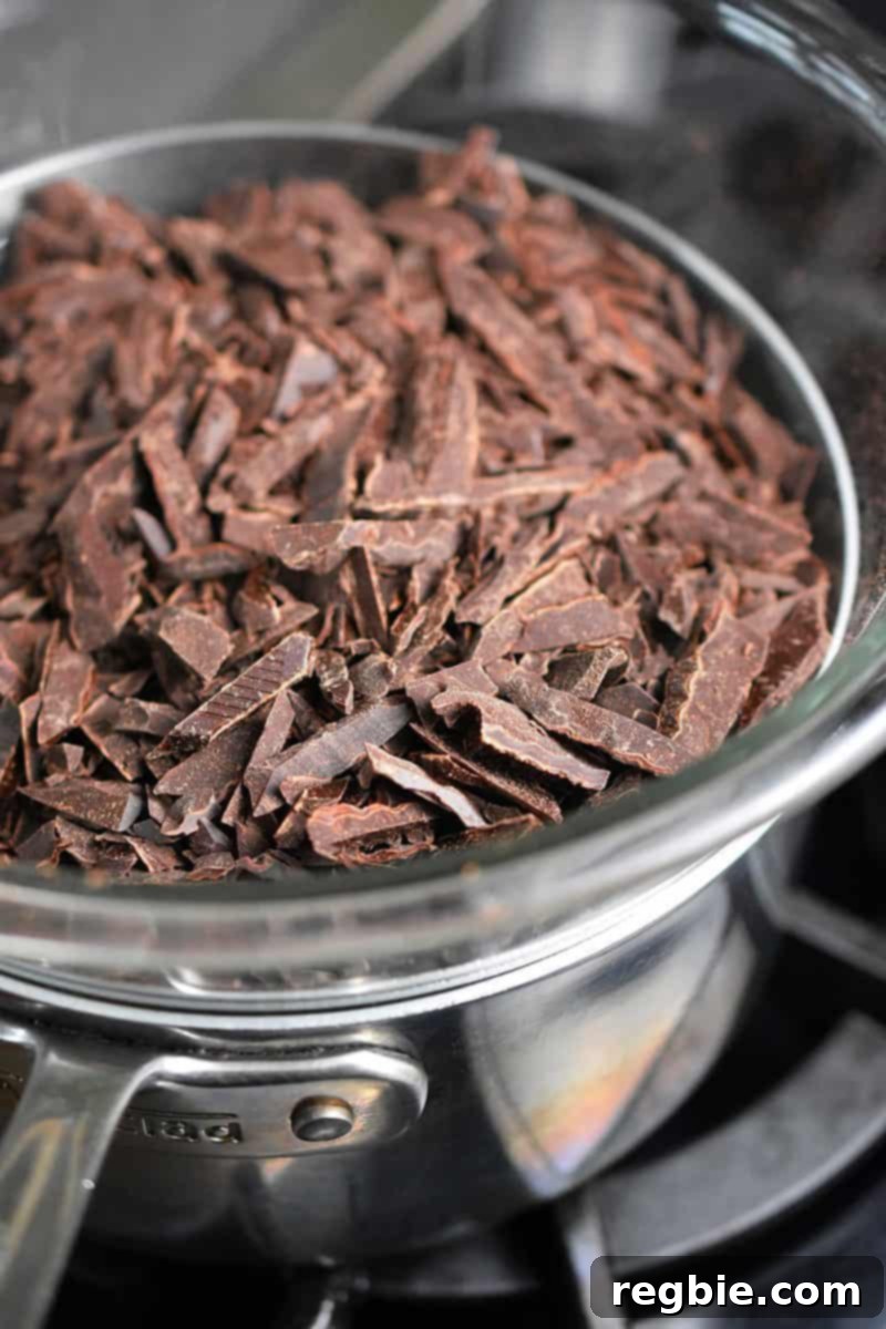 Coco-Nutty Dark Bark by Michelle Tam / Nom Nom Paleo https://nomnompaleo.com showing chocolate melting over a double boiler setup.