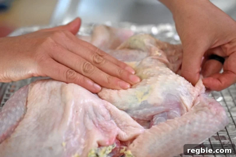 Transform Chicken with Herb Butter Spatchcock Juicy and Crispy 17 Massaging the herb butter under the skin to distribute it evenly all over the chicken for optimal flavor.