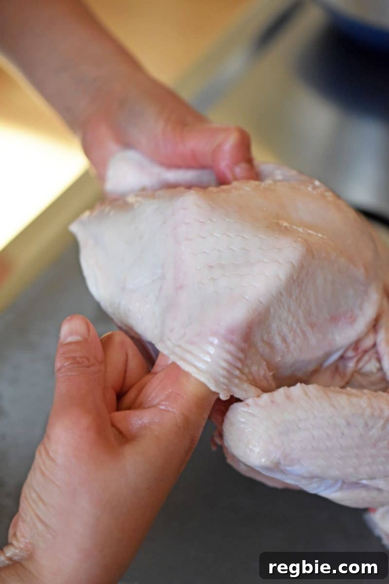 Transform Chicken with Herb Butter Spatchcock Juicy and Crispy 9 Sticking two fingers below the skin of the chicken to loosen it from the meat, creating pockets for flavor.