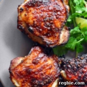 An overhead shot of Vietnamese Lemongrass Chicken on a plate with fresh herbs.
