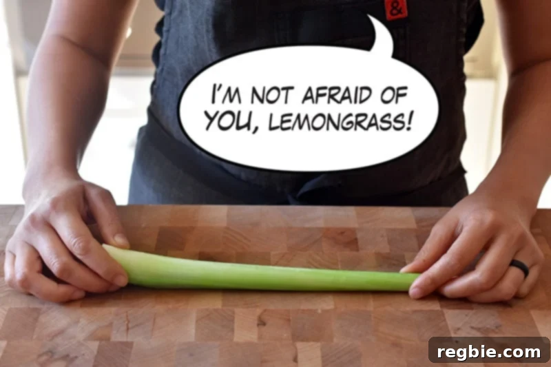 Lemongrass Cooking Guide 2 A person holding a stalk of lemongrass on a wooden cutting board with a cartoon word bubble that says, "I’m not afraid of you, lemongrass!"