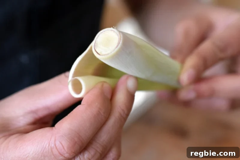 Lemongrass Cooking Guide 5 Peeling off the tough outer layer on a lemongrass stalk.