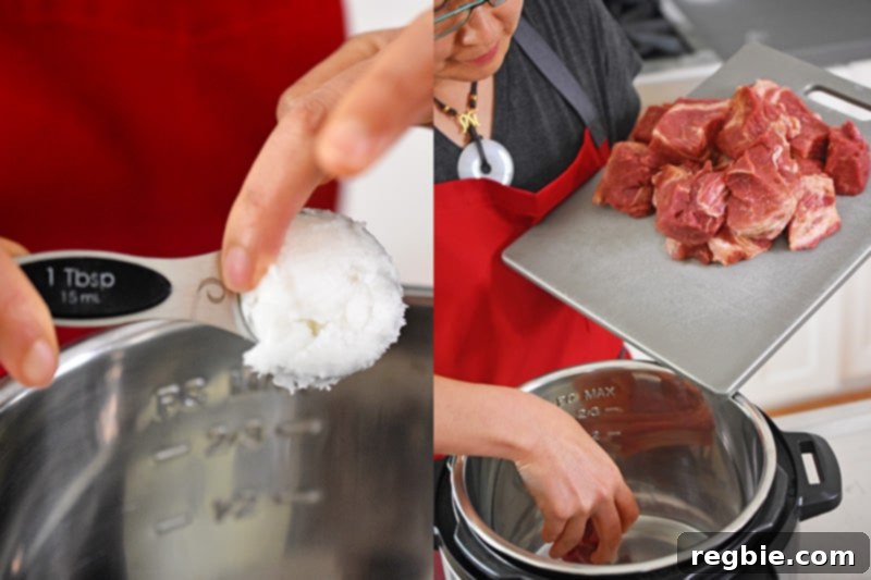 Adding coconut oil and the seasoned pork cubes to an open Instant Pot.